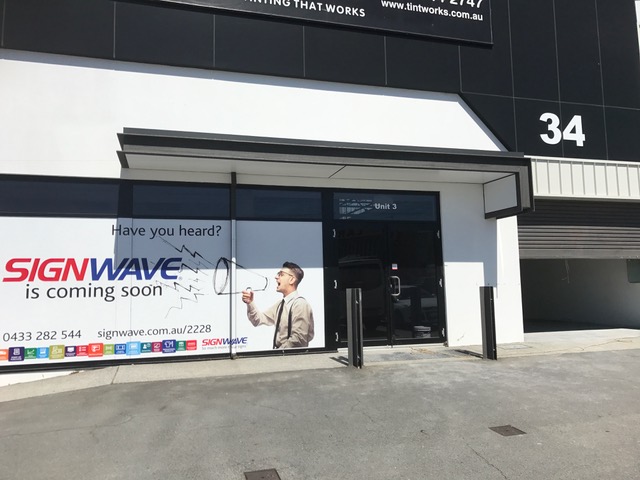 signwave coming soon sign and building